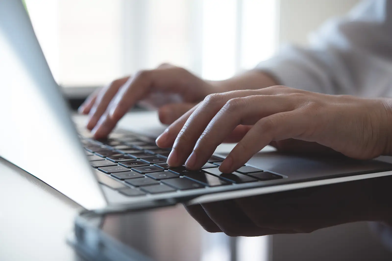 Professional typing on a laptop